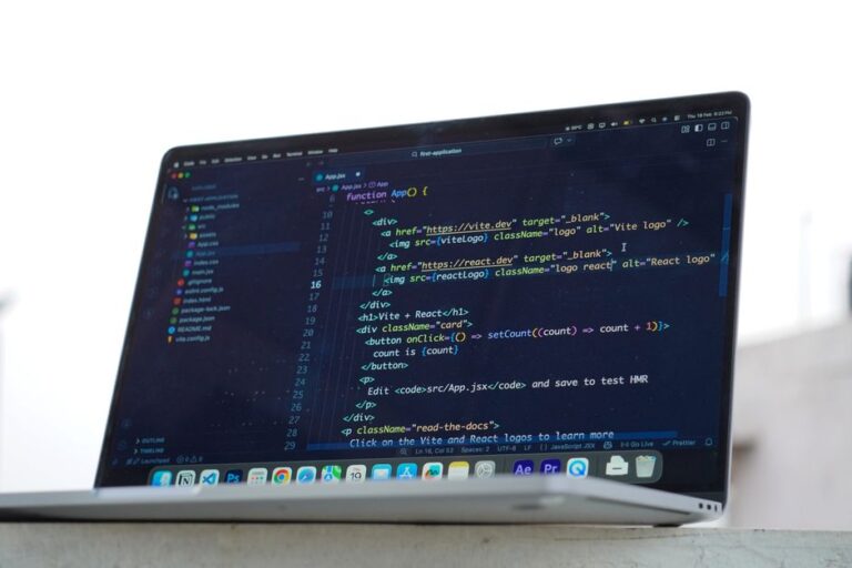 A developer codes on a laptop in an outdoor setting, showcasing modern web development in Surat, India.