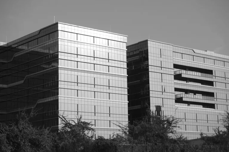 Black and white photo of modern office buildings in Bengaluru, India, showcasing architectural design.