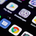 App Store au Royaume-Uni : Apple conteste 2 milliards, ça pique Close-up image of a smartphone screen displaying various app icons on a dark background.
