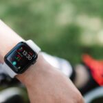 Apple Watch : l'alerte hypertension autorisée en Australie, mais encore inactive Close-up of a smartwatch on a wrist showing health metrics outdoors on a sunny day.