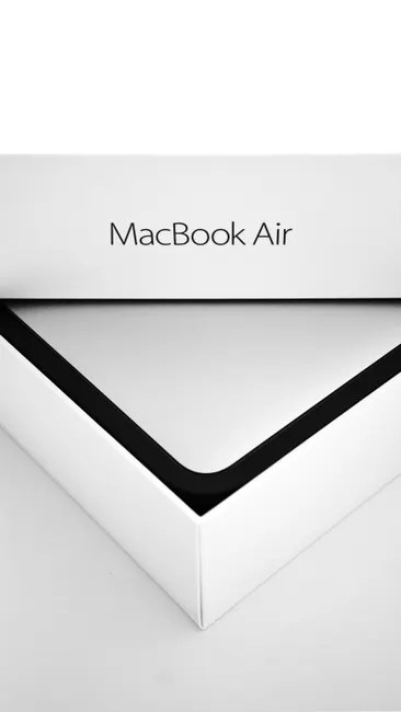 Close-up shot of a MacBook Air box, emphasizing minimalist design and elegance.