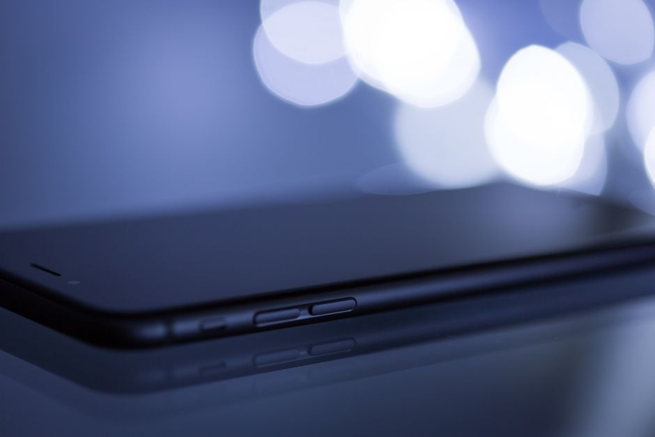 Close-up shot of a sleek smartphone with a blurred bokeh background, emphasizing its modern design.