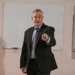 Professional presenter delivering a business talk in a conference room.