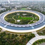 Stunning aerial view of the modern Apple Park in Cupertino, showcasing its unique circular design and lush greenery.