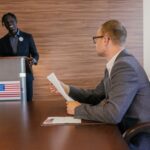 Tim Cook et Trump en 2025 : la pomme sous pression Two professionals in discussion during a political meeting in a modern conference room.