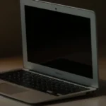 A clean and minimalist close-up of a MacBook Air on a desk, perfect for tech and lifestyle themes.