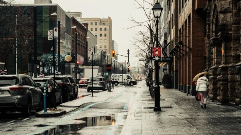A rainy day scene on Sainte-Catherine Street in Montreal capturing urban life and architecture.