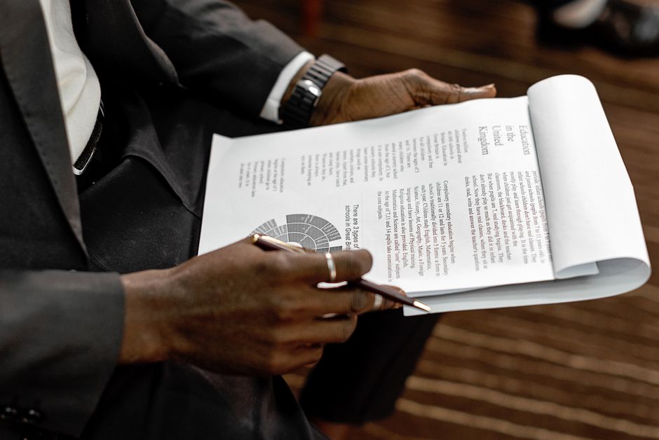 Business professional reviewing financial documents with charts and graphs during a meeting.