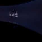 Dell UltraSharp 52 : 6K, 120 Hz et 2 899,99 dollars, le bureau XXL Curved monitor screen showing ChatGPT interface in low-light, focus on technology and AI.