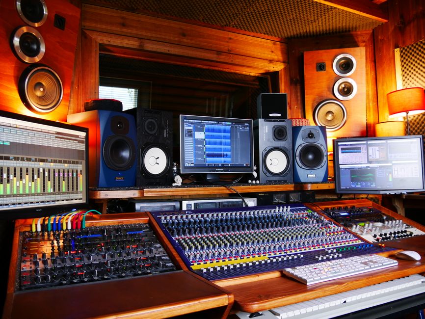 High-quality sound mixing desk and monitors in professional recording studio.